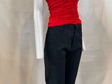 the mannequin is wearing a red top and black pants