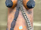 an image of a clay mask with a chain around it