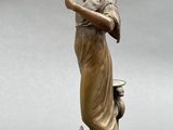 bronze statue of a woman holding a mirror and a dog