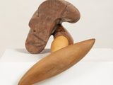 sculpture of a wooden object with a knife on top of it