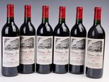 six bottles of red wine are lined up in a row