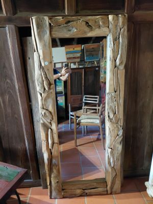 a mirror in the corner of a room with a chair