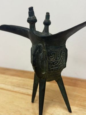 une image représentant un petit objet métallique posé sur une table en bois