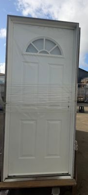 a white door sitting on top of a pallet in a parking lot