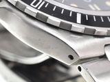 a close up of a watch with a black face