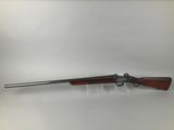 a rifle with a wooden barrel and a metal handle