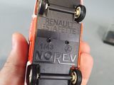 a person holding a miniature skateboard in their hand