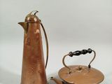 a small copper teapot and a small copper teapot on a white background