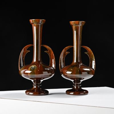 two vases that are sitting on a white table