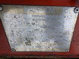 a metal plaque on the side of a red truck