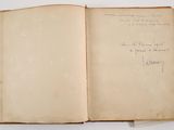 an open book with writing on it sitting on a table