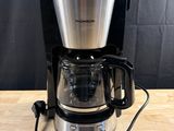 the coffee maker is on the table ready to be used