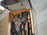 a box with a gun inside of it on the floor