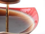 a close up of a red bowl with a spoon in it