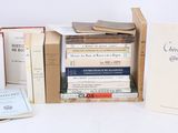 several books are stacked on top of each other on a table