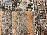 close up of a rug with a pattern of different colors and sizes