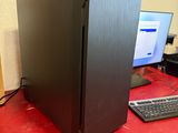 a desktop computer sitting on a red desk next to a keyboard