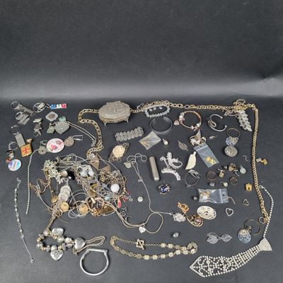 an assortment of jewelry including a necklace, bracelet, ring, and other items