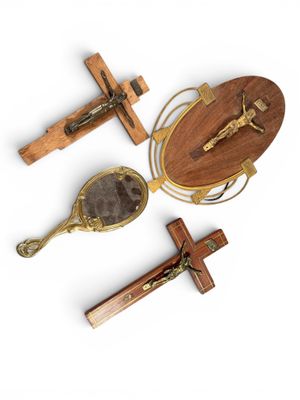 three wooden crucifts and a wooden spoon on a white background