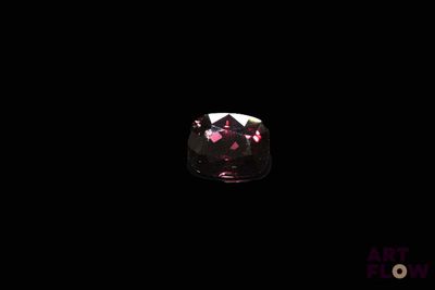 a close up of a pink diamond on a black background