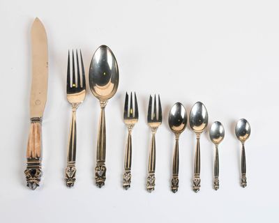 a lot of silverware on the table with a knife and fork