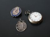 three different types of pocket watches are displayed on a black surface