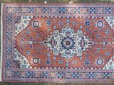 a red and blue rug on the ground
