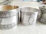 three silver cups sitting on a table next to each other
