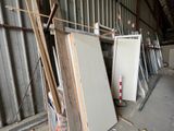 many pieces of white refrigerators in a warehouse
