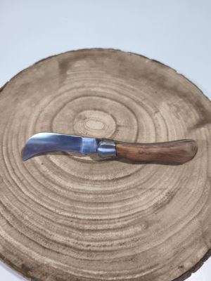 a knife that is sitting on top of a piece of wood