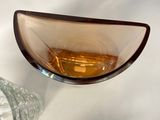 a glass bowl sitting on a table next to a glass bowl