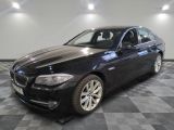 a picture of a black bmw car in a showroom
