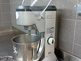 a mixer and a whisk on the counter in the kitchen