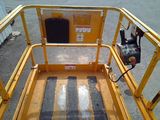 a close up of a yellow lift with a metal railing