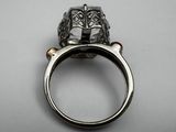 a close up of a ring on a table with a white background