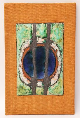 an orange canvas with a painting of a tree in the center