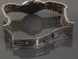 an image of a close up of a watch on a reflective surface