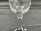 a wine glass sitting on a table with a black background