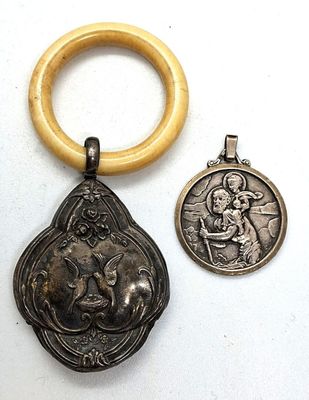 two silver and gold medals and a wooden ring on a white surface