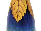 a blue vase with a yellow leaf design on it