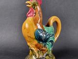 a ceramic rooster that is sitting on a table