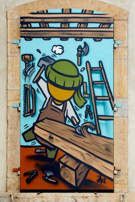 painting of a man working on a piece of wood on a wall
