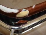 a brown and white cow hide on a chrome chair