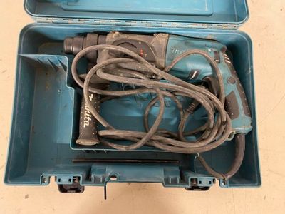 a blue box with a drill and a cord in it