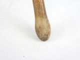 a close up of a wooden mallet on a white surface