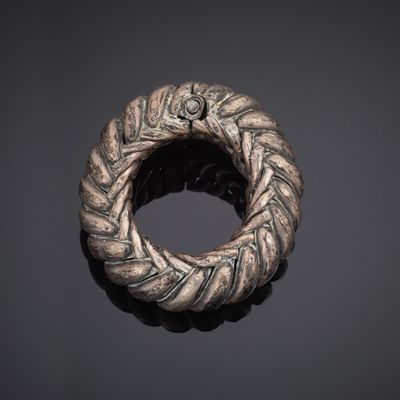 a silver ring with a braided design on it