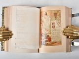 a open book with two gold hands holding it