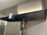 a stainless steel stove top with a ventula above it