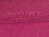 a close up of a pink purse with a name on it