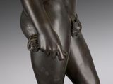 an image of a bronze statue of a woman holding her hands behind her back